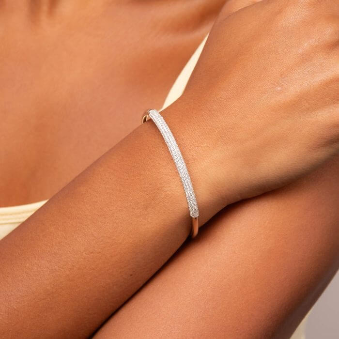 model arm with silver platinum plated Tubular Hinged Bracelet with Cubic Zirconia
