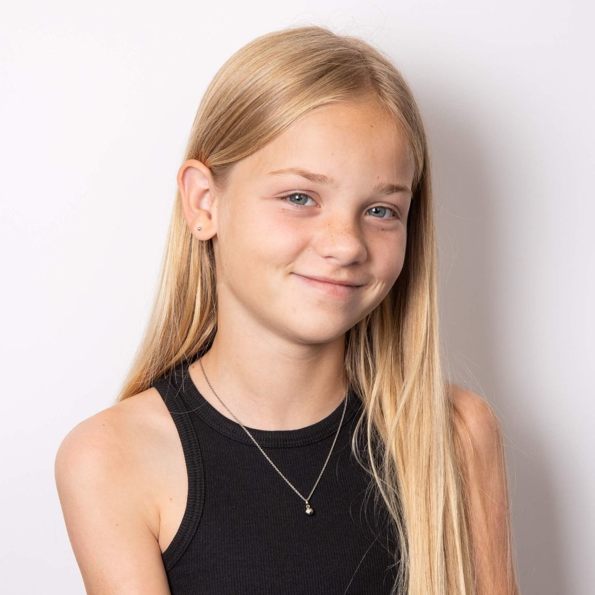 Young girl wearing A pair of Starburst Silver Stud Earrings with Diamonds