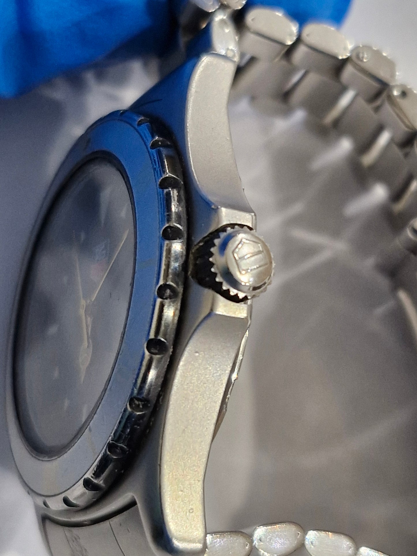 Close-up of the Tag Heuer 2000 Professional watch crown, featuring a stainless steel screw-down crown engraved with the Tag Heuer logo.