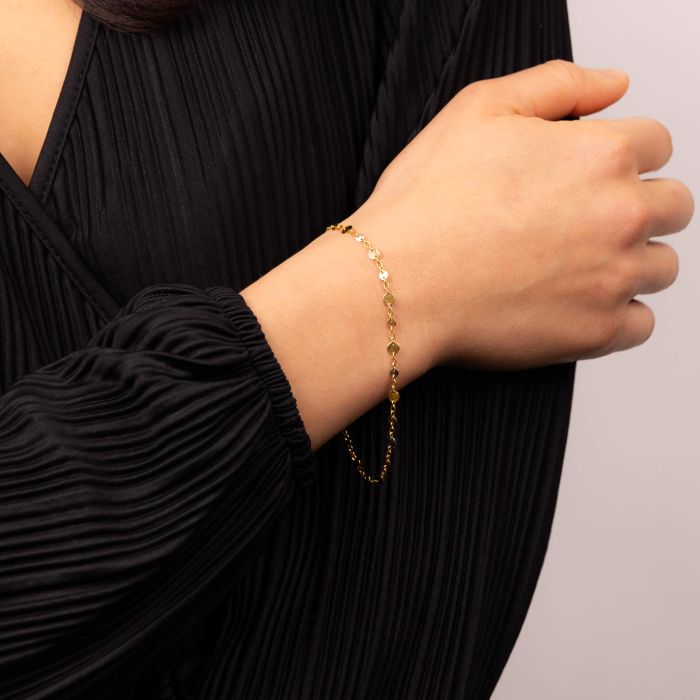 Model wearing Discs and Chain Bracelet in 9ct Gold gb525, featuring a stylish chain design with decorative discs, ideal for elegant accessories and everyday wear.