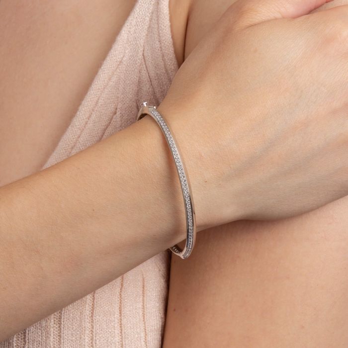 Model wearing Fiorelli Knife Edge Hinged Bangle with Cubic Zirconia b5380c, featuring a sleek knife-edge design and sparkling stone accents, perfect for elegant and modern jewelry styling.