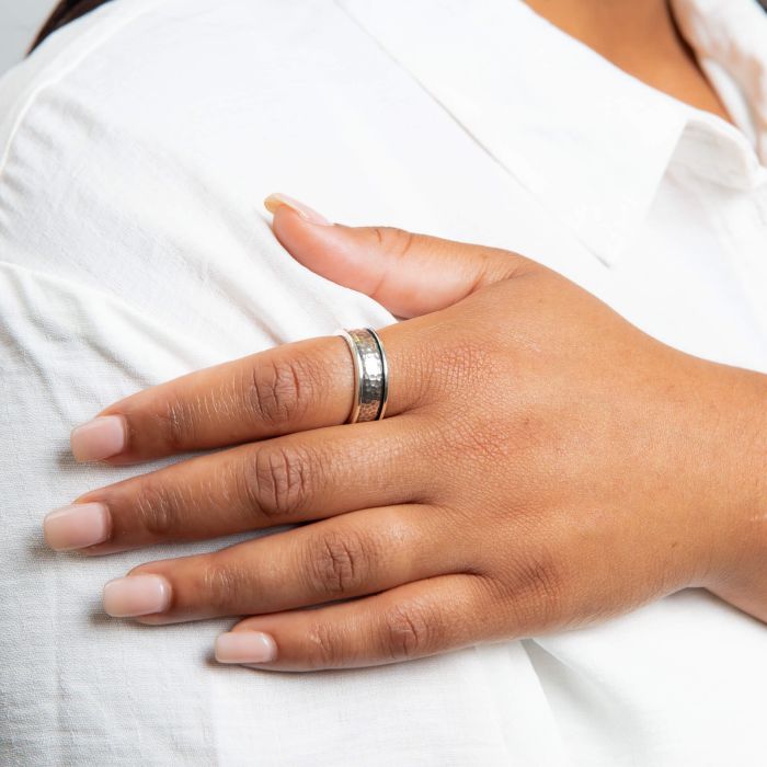 Model wearing Hammered Design Spinner Silver Ring Wide r3906, featuring a unique hammered texture with a spinning band, perfect for adding a modern and stylish statement to any outfit.