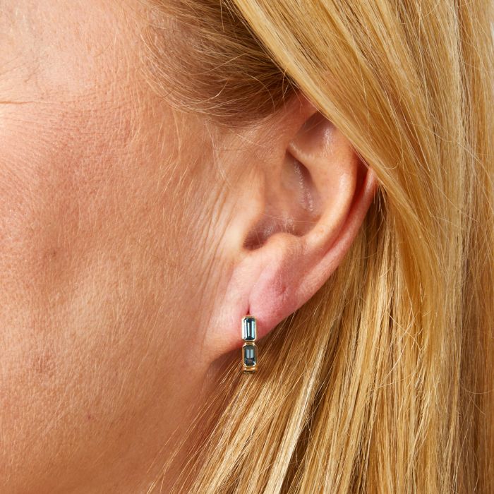 model wearing elongated half hoop topaz earrings in 9ct yellow gold