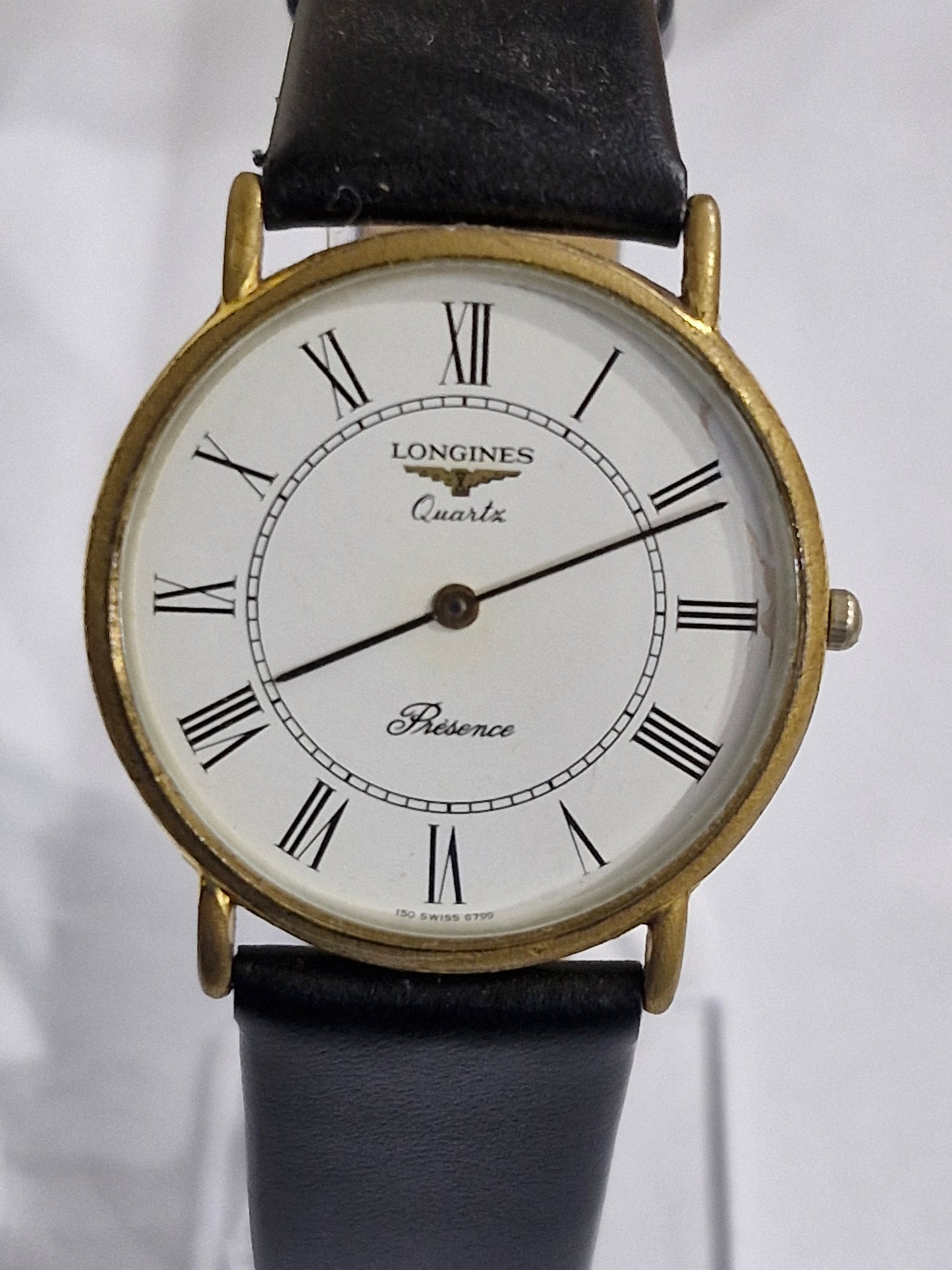 Close-up of Longines Presence white dial with Roman numerals and Swiss quartz movement
