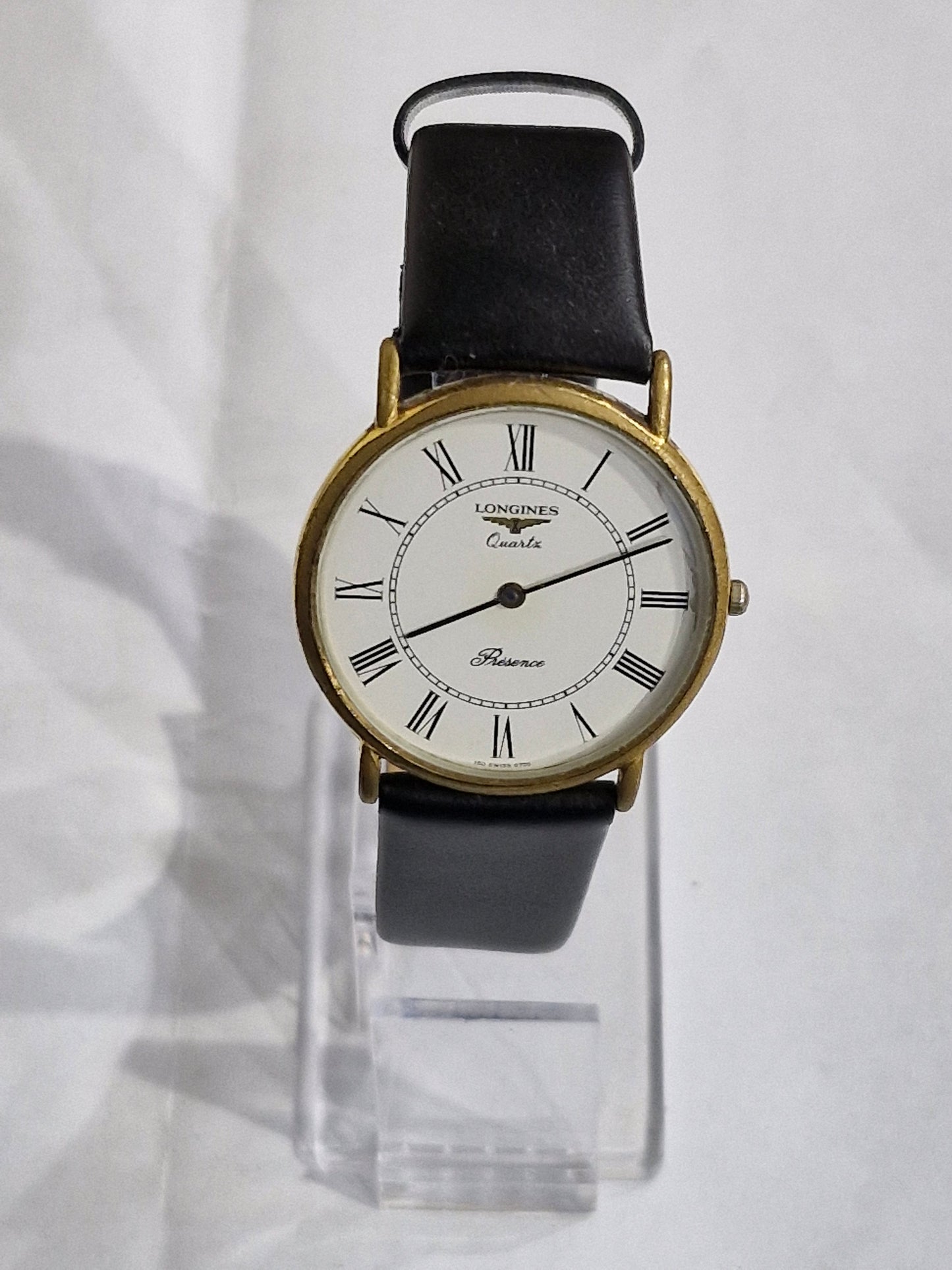 Vintage Longines Presence gold-plated watch with white Roman numeral dial and black leather strap
