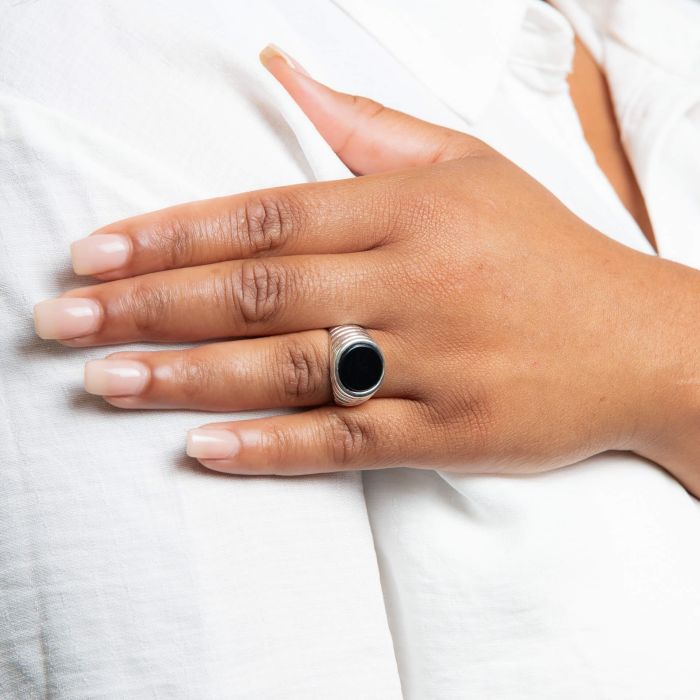 Model wearing Men’s Black Onyx Ripple Effect Silver Signet Ring r3897b, featuring a bold ripple-textured sterling silver band with a striking black onyx centerpiece, perfect for adding a modern and sophisticated touch to any look.