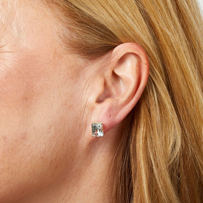 Model wearing Octagonal Fancy Cut Amethyst Stud Earrings in 9ct Gold ge2485g, featuring striking octagonal-cut amethyst gemstones set in polished 9ct gold, perfect for adding elegance and sophistication to any outfit.