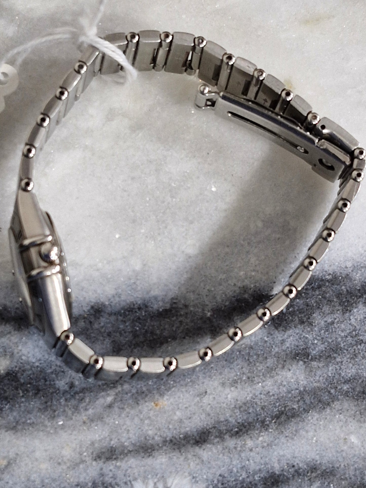 Side view of pre-owned Omega Constellation Quartz 26mm women's stainless steel watch with silver dial