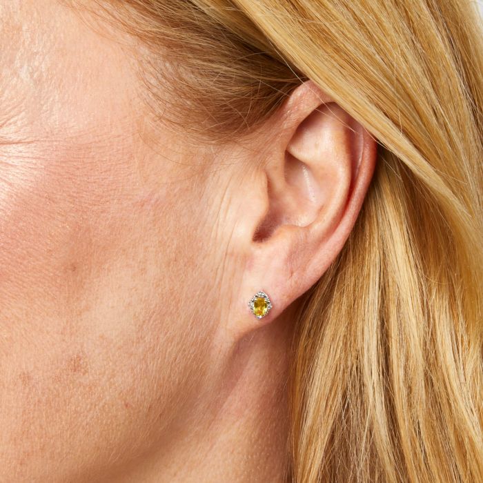 Model wearing Oval Sapphire and Diamond Stud Earrings in 9ct Gold ge2490y, featuring deep blue oval-cut sapphires surrounded by sparkling diamond accents set in polished 9ct gold, perfect for adding elegance and sophistication to any outfit.