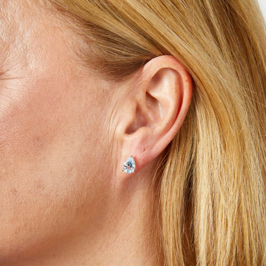 Model wearing Pear Fancy Cut Topaz Stud Earrings in 9ct Gold ge2486t, featuring stunning pear-shaped topaz gemstones set in polished 9ct gold, perfect for adding a touch of elegance and sparkle to any outfit.