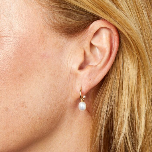 Model wearing Pearl Detail Half Hoop Earrings in 9ct Gold ge2492w, featuring elegant pearl accents set in polished 9ct gold, perfect for adding sophistication and timeless beauty to any outfit.