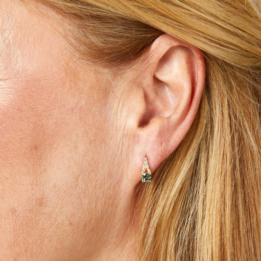 Model wearing Rose Cut Sapphire and Diamond Drop Earrings in 9ct Gold, featuring stunning rose-cut sapphires surrounded by sparkling diamonds set in polished 9ct gold, perfect for adding elegance and sophistication to any outfit.