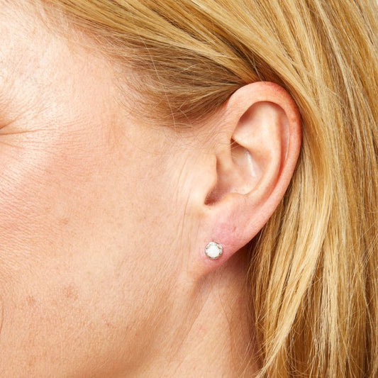 Model wearing Round Diamond Surround Opal Stud Earrings in 9ct Gold ge2487w, featuring a stunning opal center surrounded by sparkling round diamonds set in polished 9ct gold, perfect for adding elegance and a touch of color to any outfit.