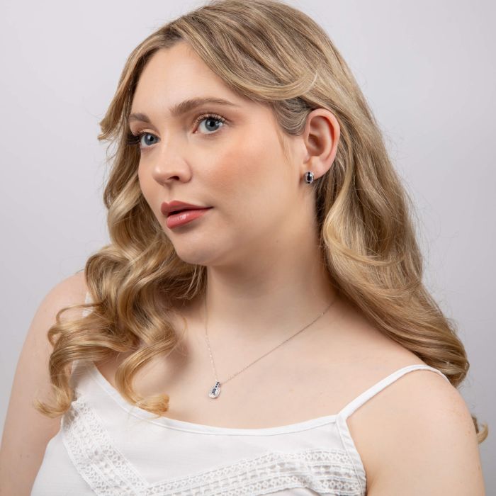 Model wearing Sapphire Channel and Diamond Stud Earrings in 9ct Gold ge2474l paired with matching Necklace gn403l, featuring deep blue sapphires set in a sleek channel design with sparkling diamond accents, perfect for an elegant and sophisticated jewelry set.