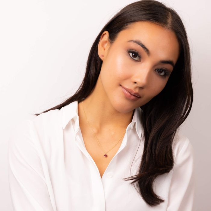 Model wearing Seven Stone Ruby Cluster Earrings in 9ct Gold ge2462r_gp2351r, featuring a stunning cluster of seven vibrant rubies set in polished 9ct gold, perfect for adding elegance and a pop of color to any outfit.