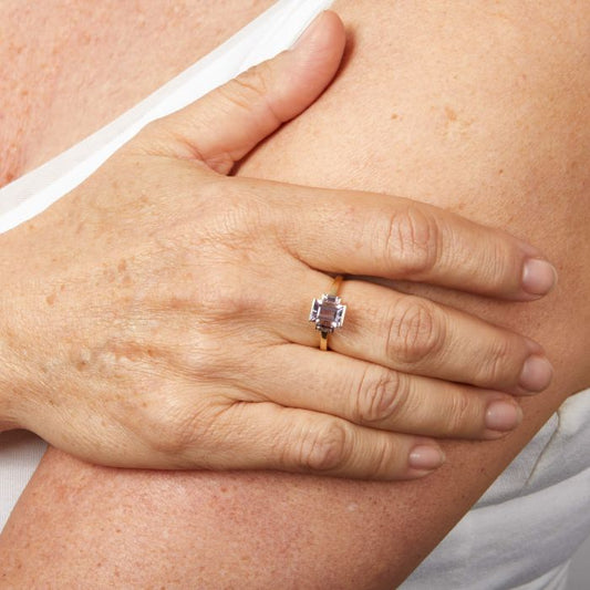 Model wearing Trilogy Amethyst Ring in 9ct Gold gr636m, featuring three stunning deep purple amethyst gemstones set in polished 9ct gold, symbolizing past, present, and future, perfect for adding elegance and meaning to any outfit.
