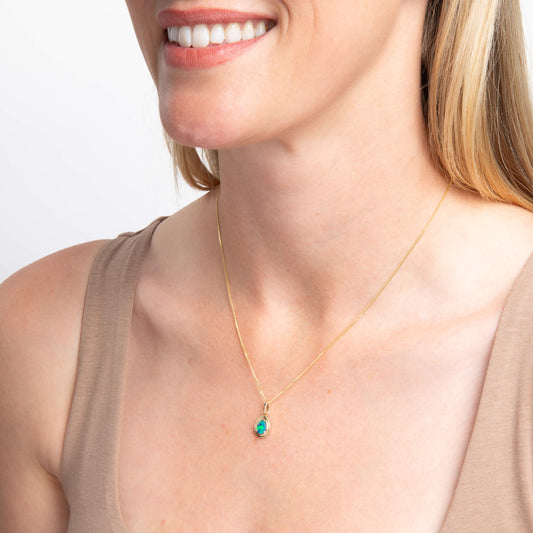 close up of woman neck wearing Opal Doublet Teardrop Pendant necklace on white background