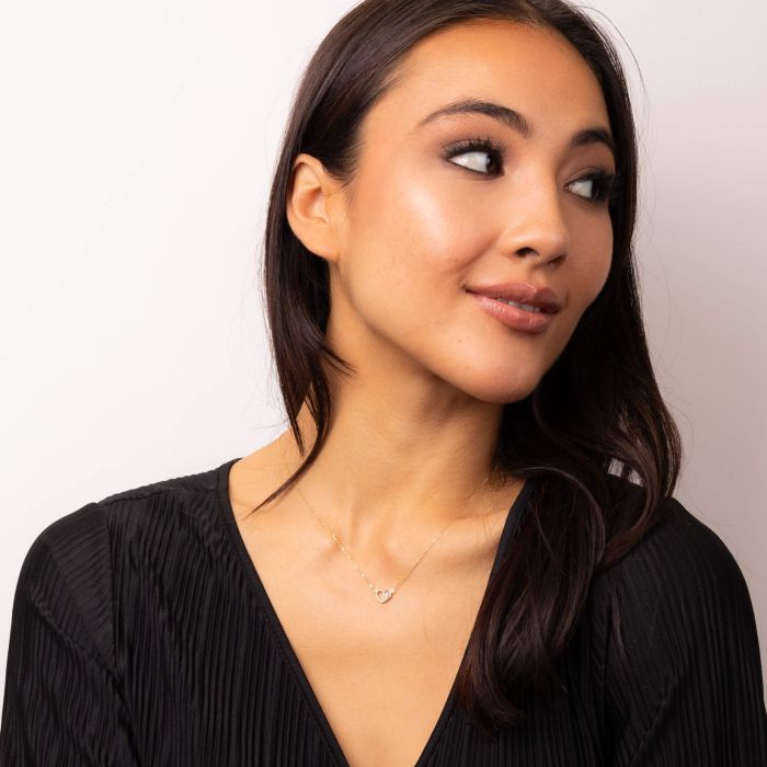 Model showcasing Gold Pearl Heart Necklace in 9ct Gold gn391w, featuring a heart-shaped pendant with lustrous pearl inlay, set in polished 9ct gold, perfect for adding a touch of elegance and romance to any jewelry collection.