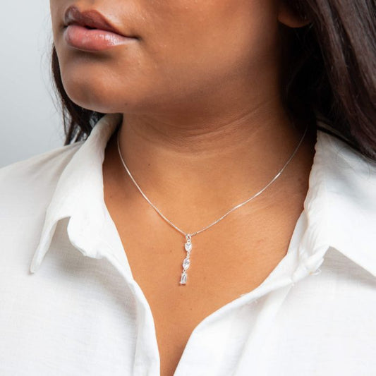 Mixed Shapes silver Long Pendant necklace worn by a person close up