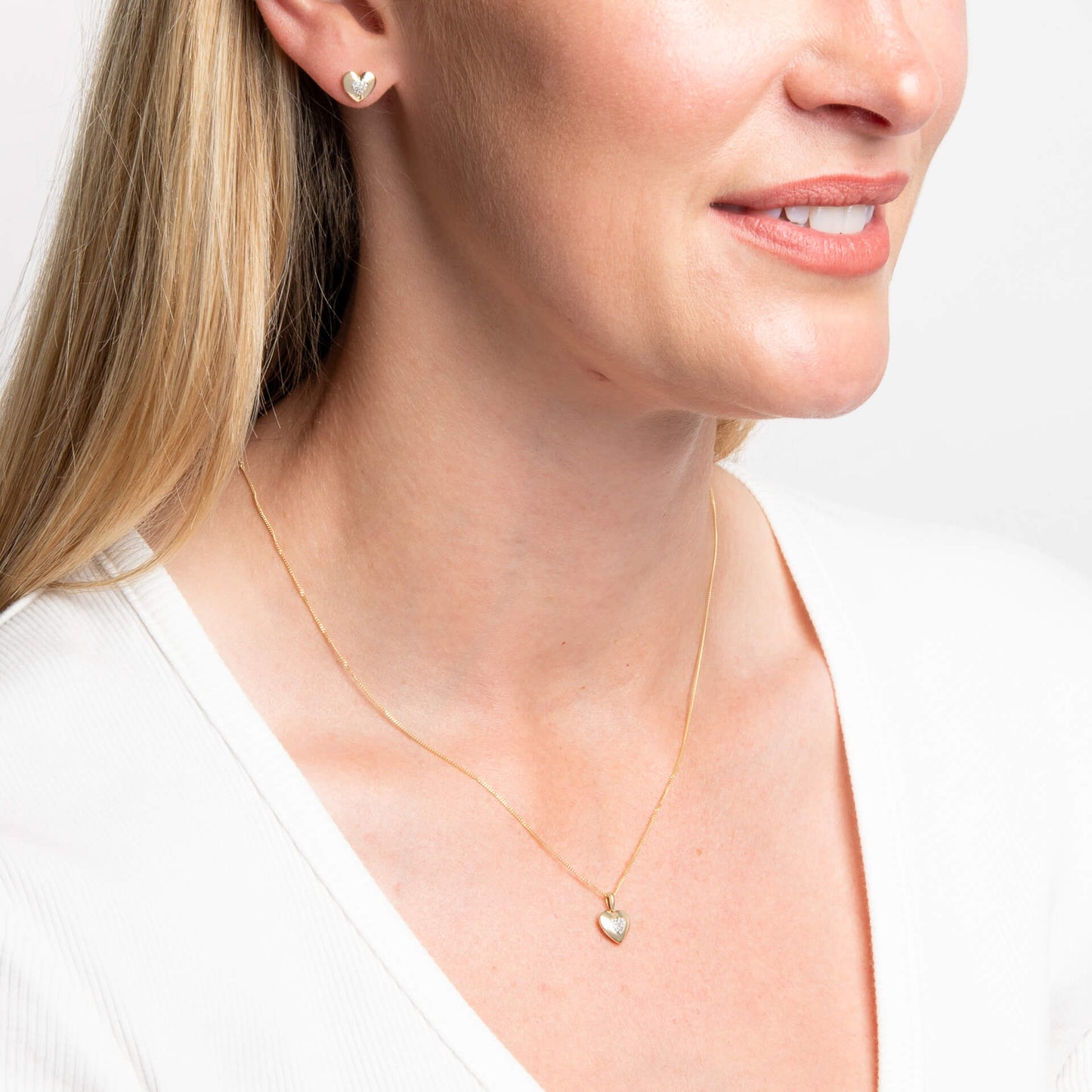 woman wearing Gold Pavé Diamond Heart Pendant & Chain and earring set