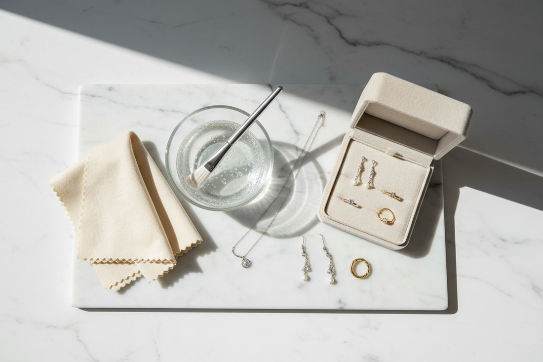jewellery care by Silverage London jewellery box with jewellery on marble board with brush glass bowl with water and jewellery polishing cloth