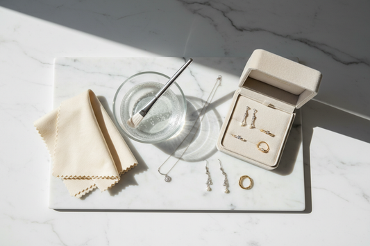 jewellery care by Silverage London jewellery box with jewellery on marble board with brush glass bowl with water and jewellery polishing cloth
