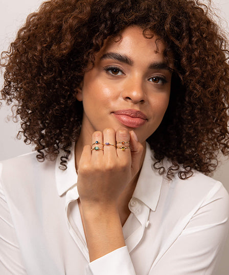 person with variety of rings on hand 