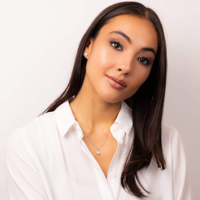 A model with brown hair wearing a beautiful pair of A pair of Bezel Set Diamond Cluster Stud Earrings in 9ct Gold 