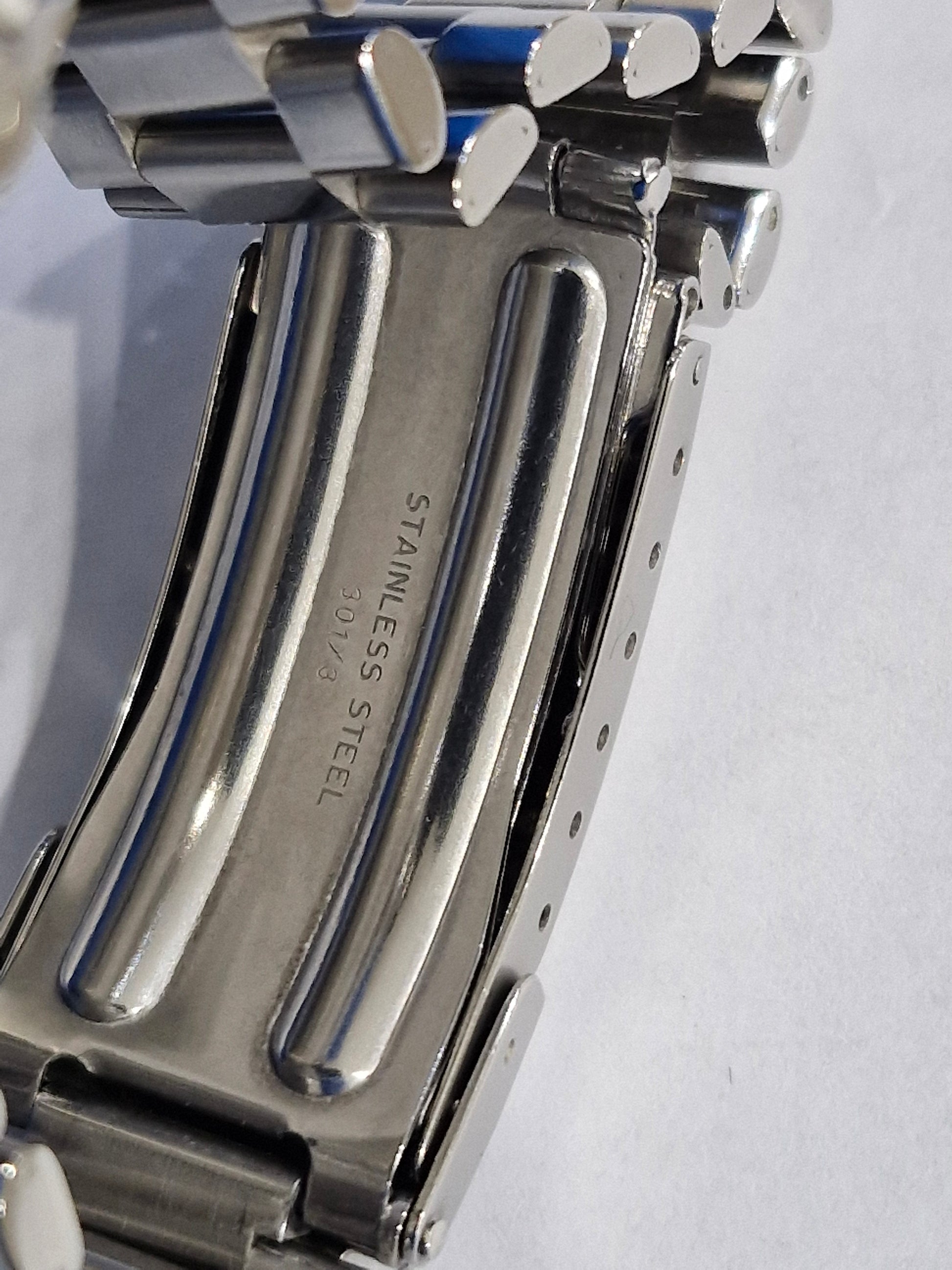 Close-up of the Tag Heuer 2000 Professional watch clasp, showing the stainless steel folding deployment clasp with engraved Tag Heuer logo.