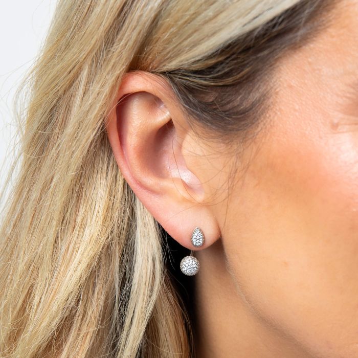 model wearing Front and back style earrings crafted from recycled sterling silver with platinum plating, featuring pave cubic zirconia stones. These interchangeable earrings allow customization with detachable drop sections, offering multiple styling options from classic stud to elegant drop earrings. Ethically sourced, responsibly manufactured, and certified skin-safe. Presented in a protective gift box for safe transit