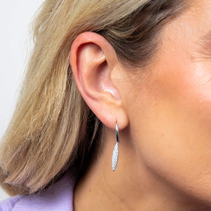 Model wearing Fiorelli Long Navette Drop Earrings e6451c, featuring an elegant navette-shaped design with sparkling cubic zirconia accents, perfect for adding a touch of sophistication to any look.