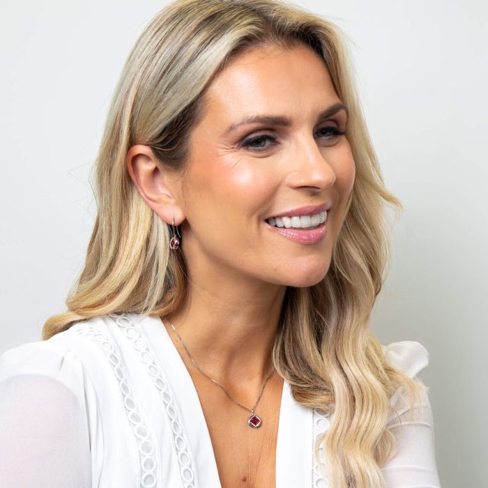 Model wearing Fiorelli Mixed Shape Fuchsia Crystal Earrings e6459p paired with Mixed Shape Fuchsia Crystal Pendant p5438p, featuring a coordinated bold design with mixed-shaped fuchsia crystals, perfect for adding vibrant elegance and sophistication to any outfit.