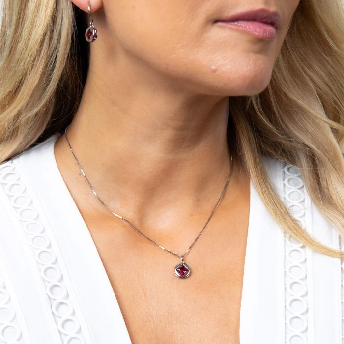 Model wearing Fiorelli Mixed Shape Fuchsia  Crystal Pendant p5438p, featuring a vibrant design with mixed-shaped fuchsia Red crystals and sparkling accents, perfect for adding a bold and elegant touch to any outfit.