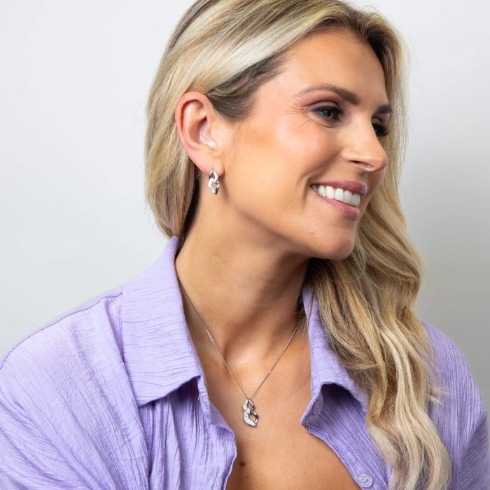 Model wearing Fiorelli Pave Chain Link Drop Earrings p5433c paired with e6454c, featuring a modern chain link design with sparkling pave cubic zirconia accents, perfect for elegant and contemporary jewelry styling.