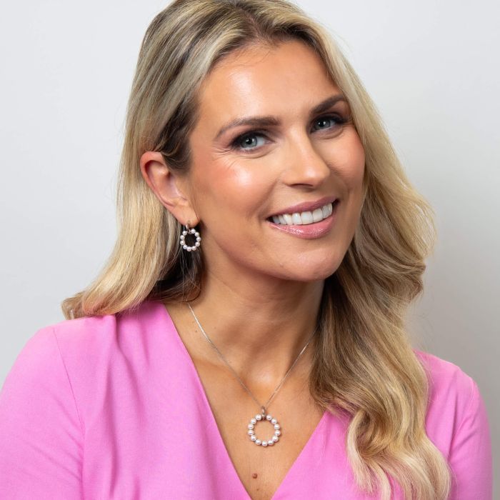 Model wearing Fiorelli Pearl Circle Earrings p5436w paired with e6456w, featuring an elegant circular design with lustrous pearls, perfect for creating a sophisticated and timeless jewelry look.