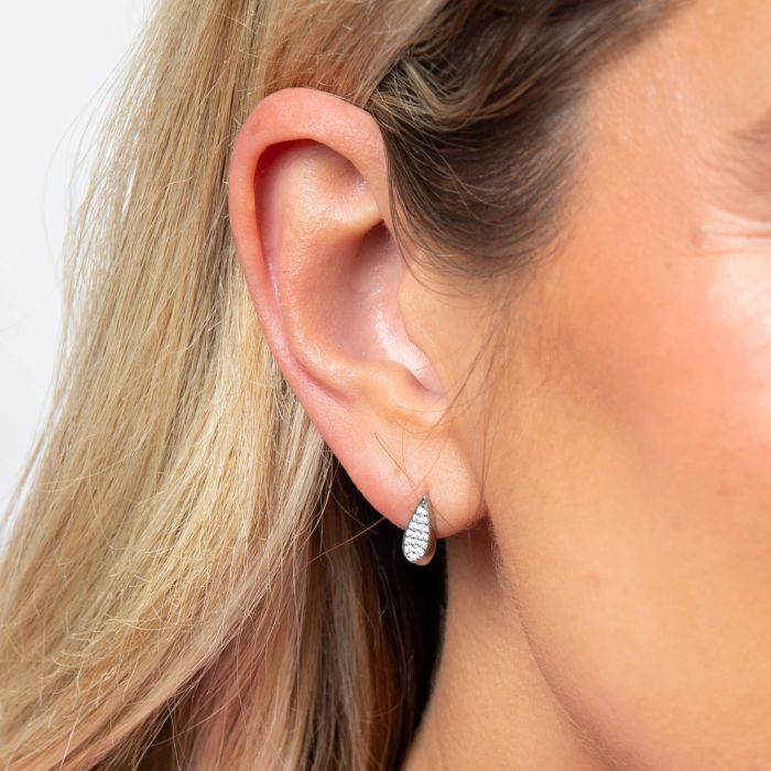 Model wearing Fiorelli Tilted Droplet Pendant e6455c, featuring a modern tilted droplet design with sparkling cubic zirconia accents, perfect for adding sophistication and elegance to any outfit.