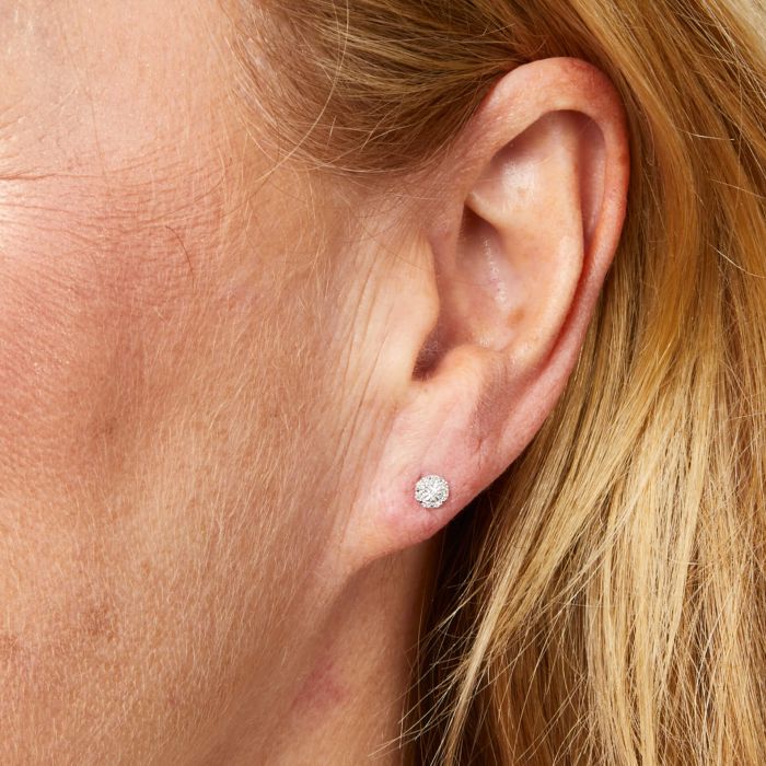 Model wearing Halo Diamond Stud Earrings in 9ct White Gold ge2477, featuring dazzling central diamonds surrounded by a halo of smaller diamonds set in polished white gold, perfect for adding timeless elegance and sparkle to any outfit.