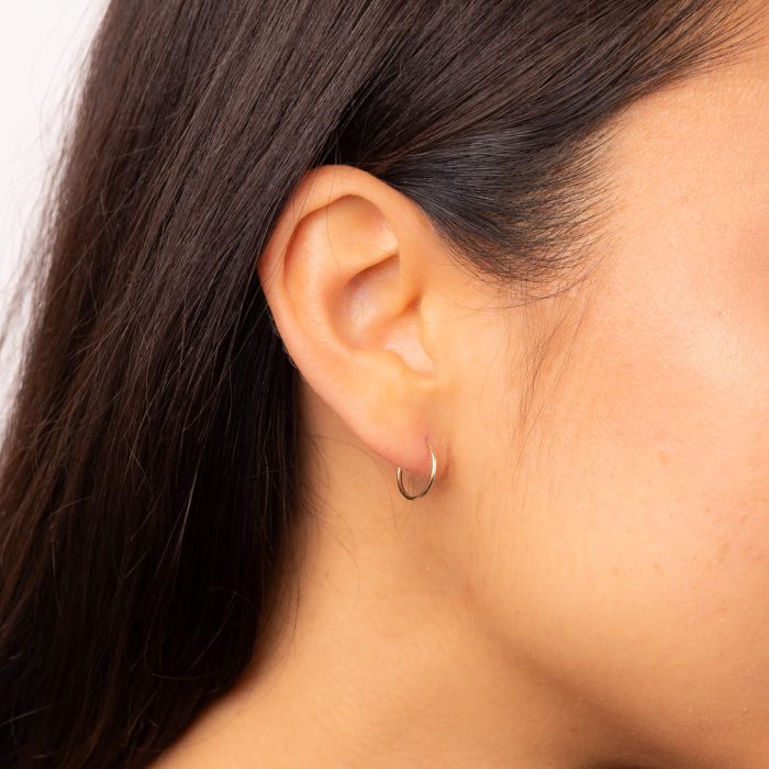 Model wearing 10mm Hoop Earrings in 9ct Gold ge2457, featuring a sleek and polished gold finish, perfect for adding timeless elegance and versatility to any outfit.
