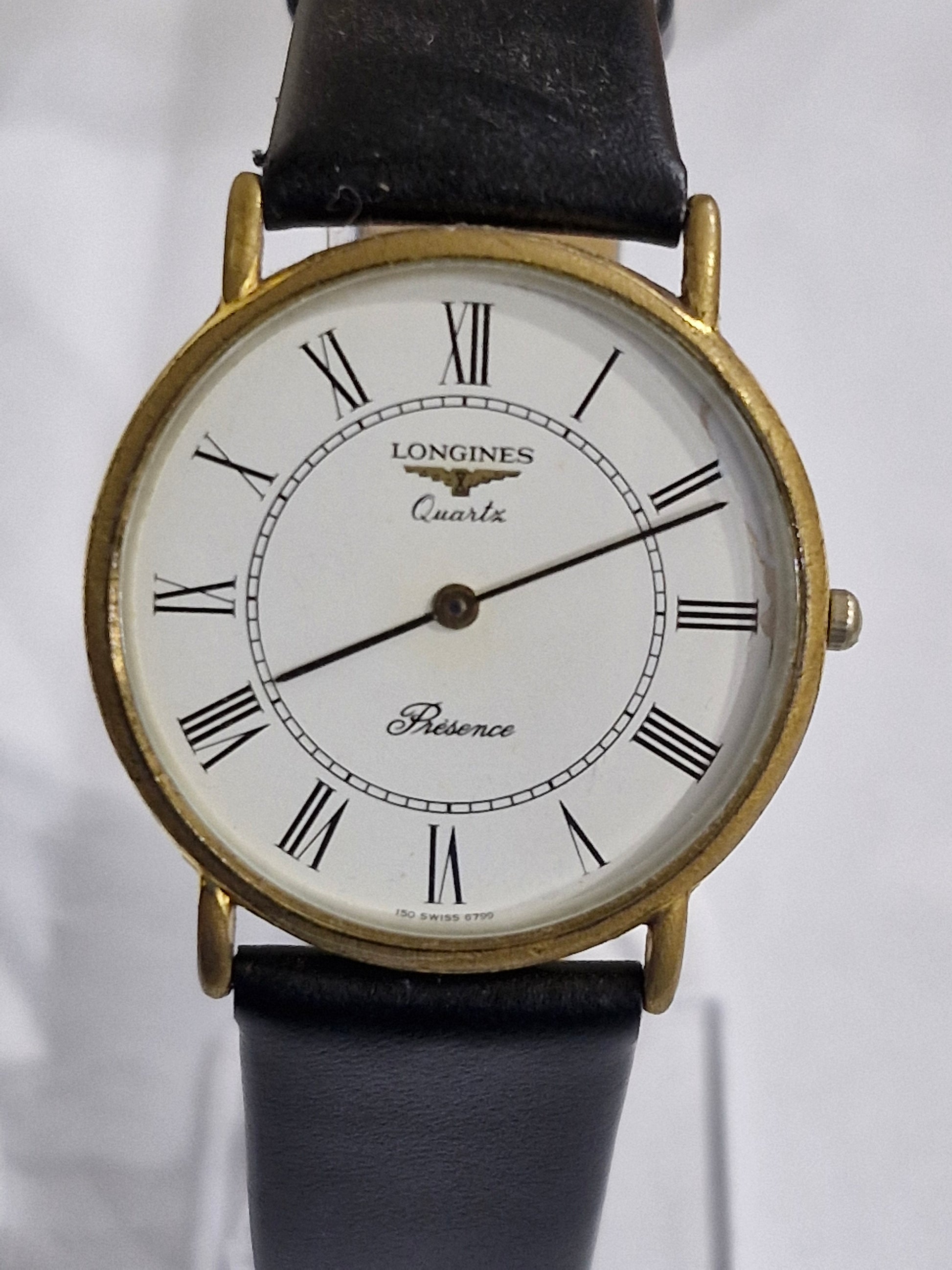 Close-up of Longines Presence white dial with Roman numerals and Swiss quartz movement
