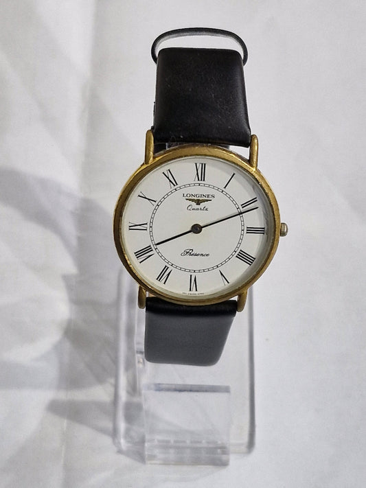 Vintage Longines Presence gold-plated watch with white Roman numeral dial and black leather strap