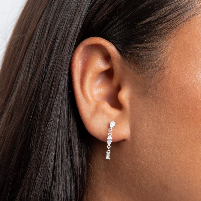 Close-up of an ear wearing a silver Mixed Shapes Long Drop Earrings clear gemstone.