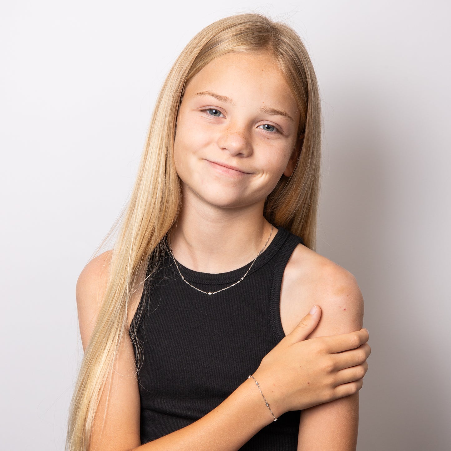 Child model wearing Star Station Necklace with Diamond n4622 paired with Star Station Bracelet b5543, featuring a delicate star-themed design with sparkling diamond accents set in polished silver, perfect as a timeless and elegant jewellery set for children.