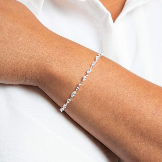 Mixed Shapes Tennis silver Bracelet on a person's wrist against a white background