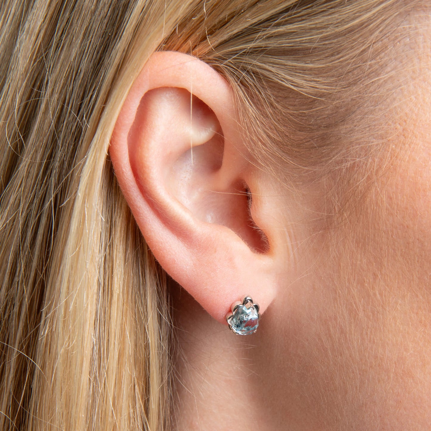 close up ear White Gold Sky Blue Topaz Flower Bud earring