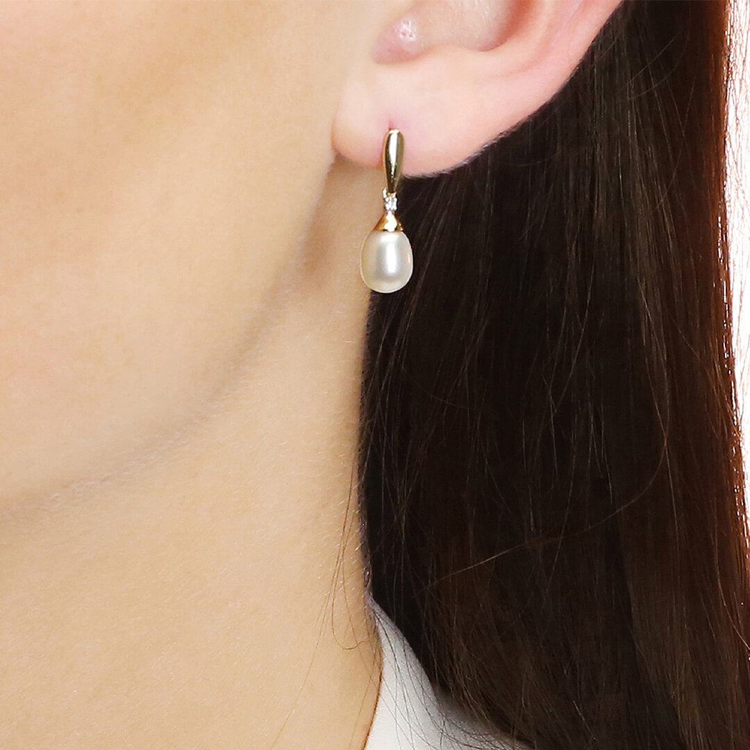 close up of ear wearing Gold Freshwater Pearl & Diamond Drop Earrings