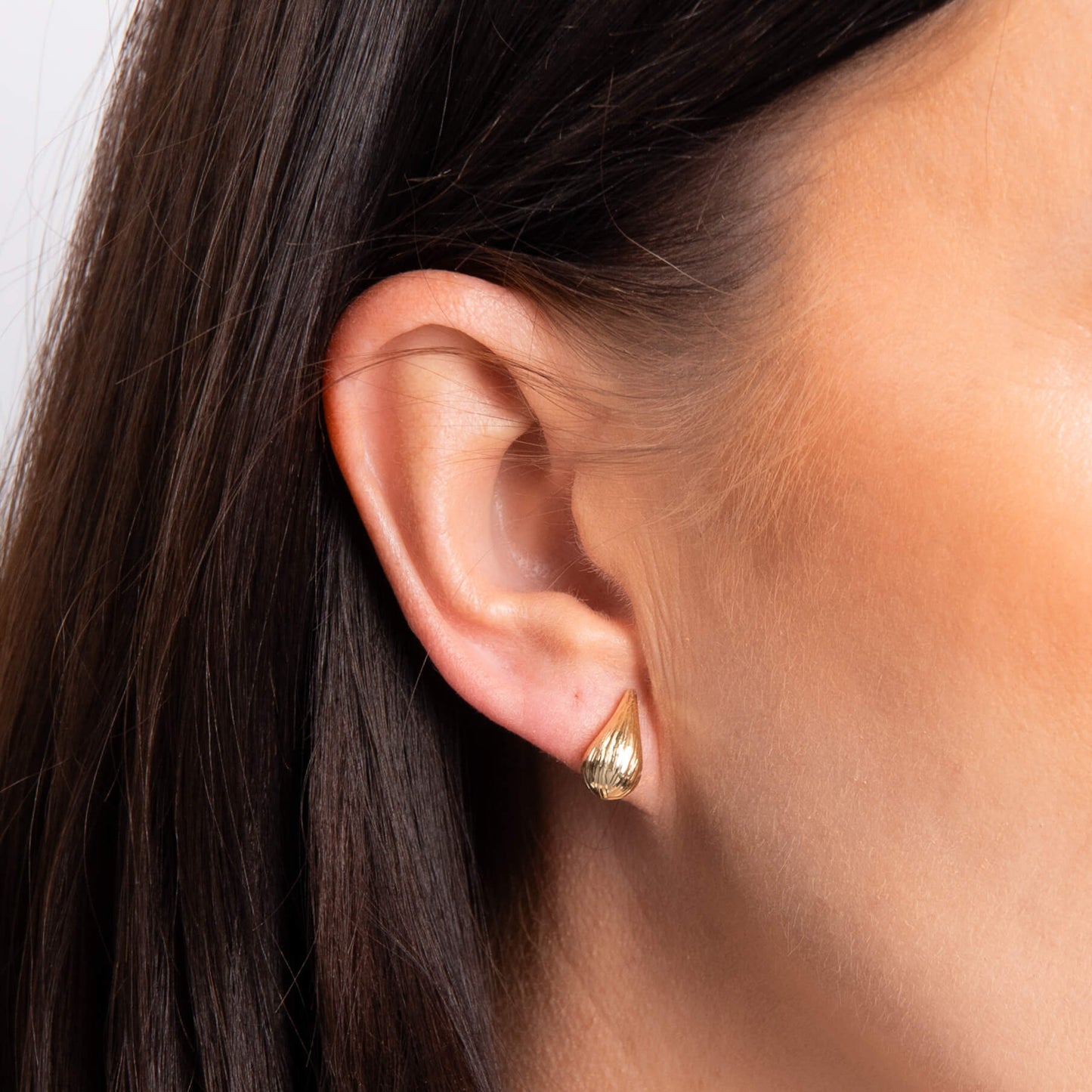 close up of ear wearing Gold Ridged Teardrop Stud Earring