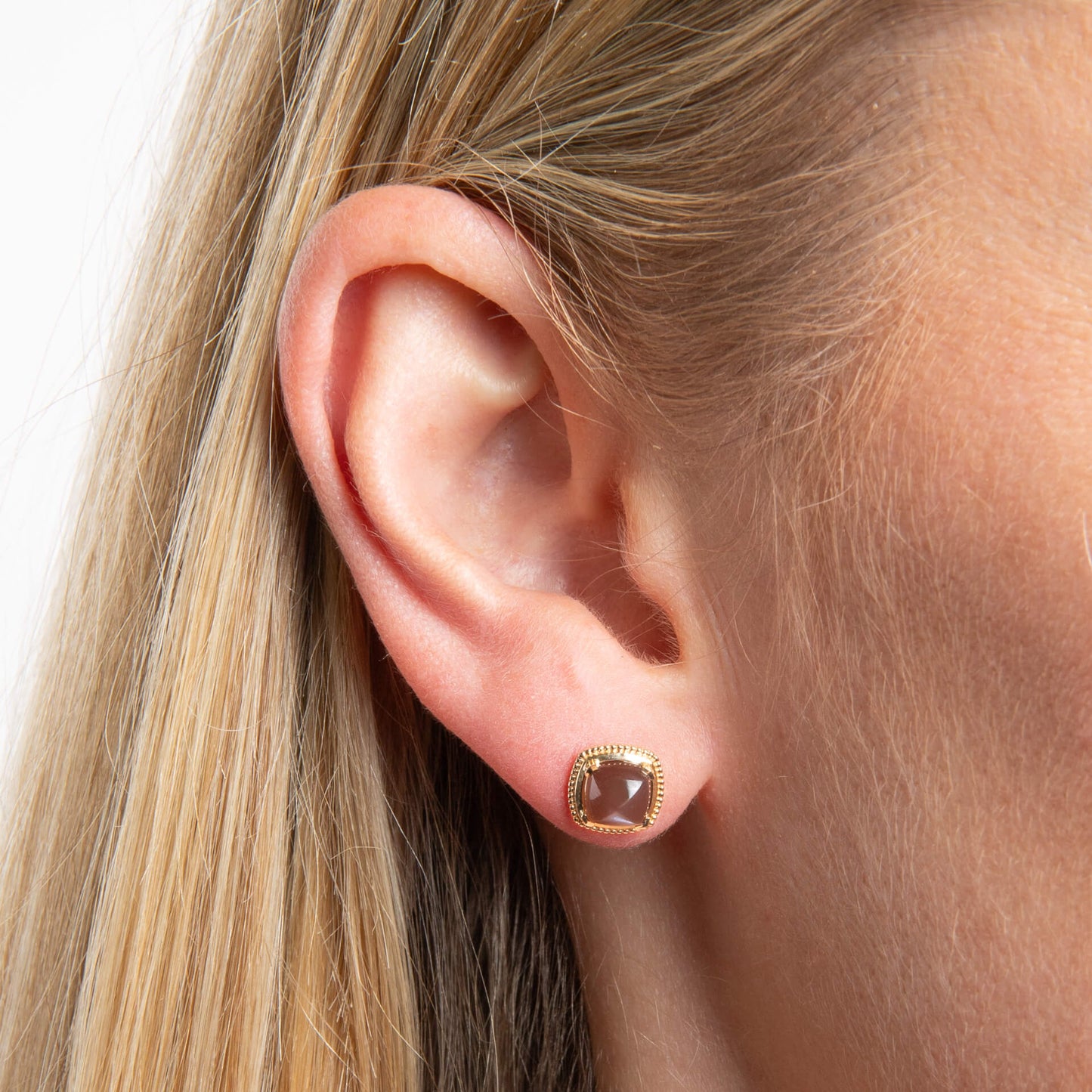 close up of ear wearing Gold Sugarloaf Cut Chocolate Moonstone earring