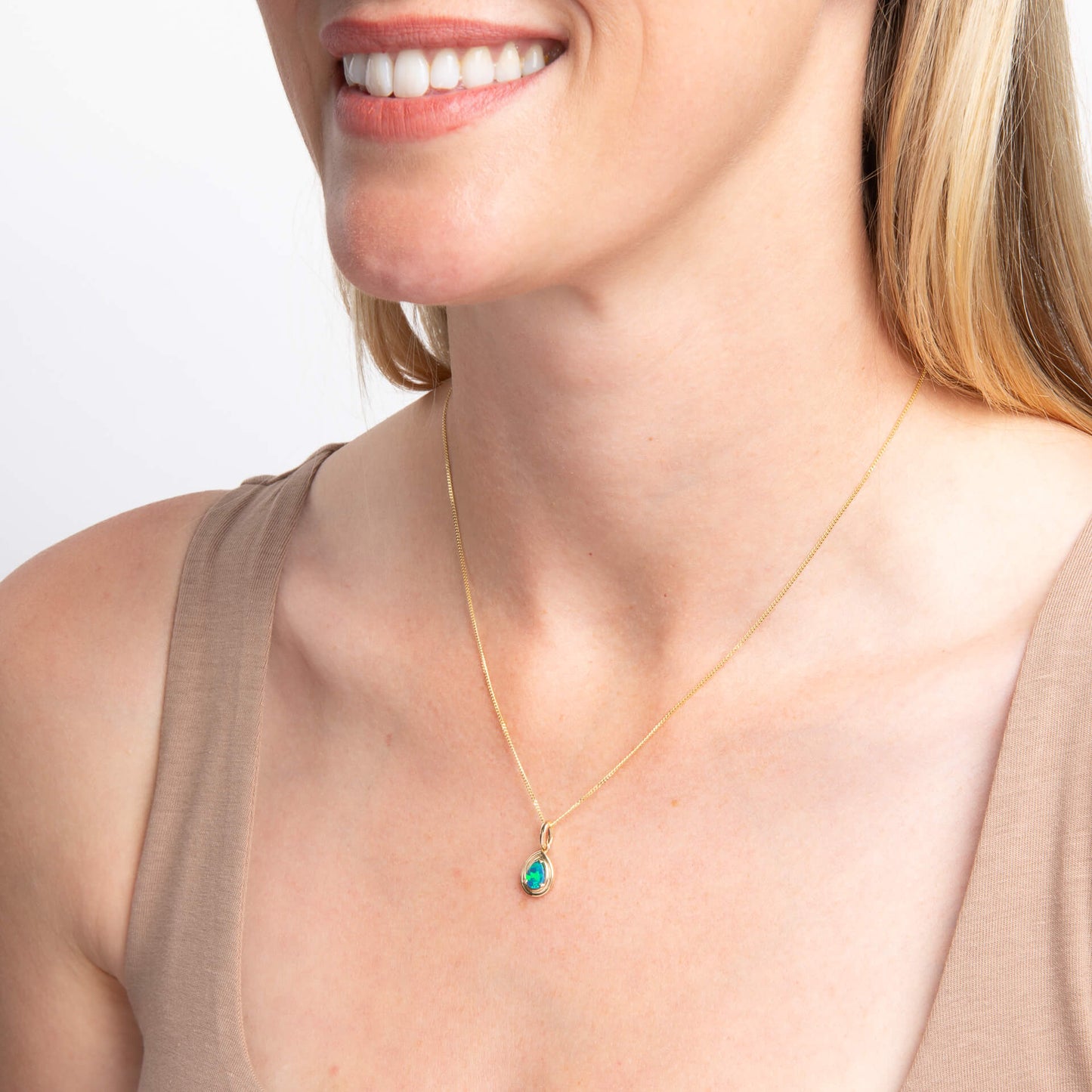 close up of woman neck wearing Opal Doublet Teardrop Pendant necklace on white background