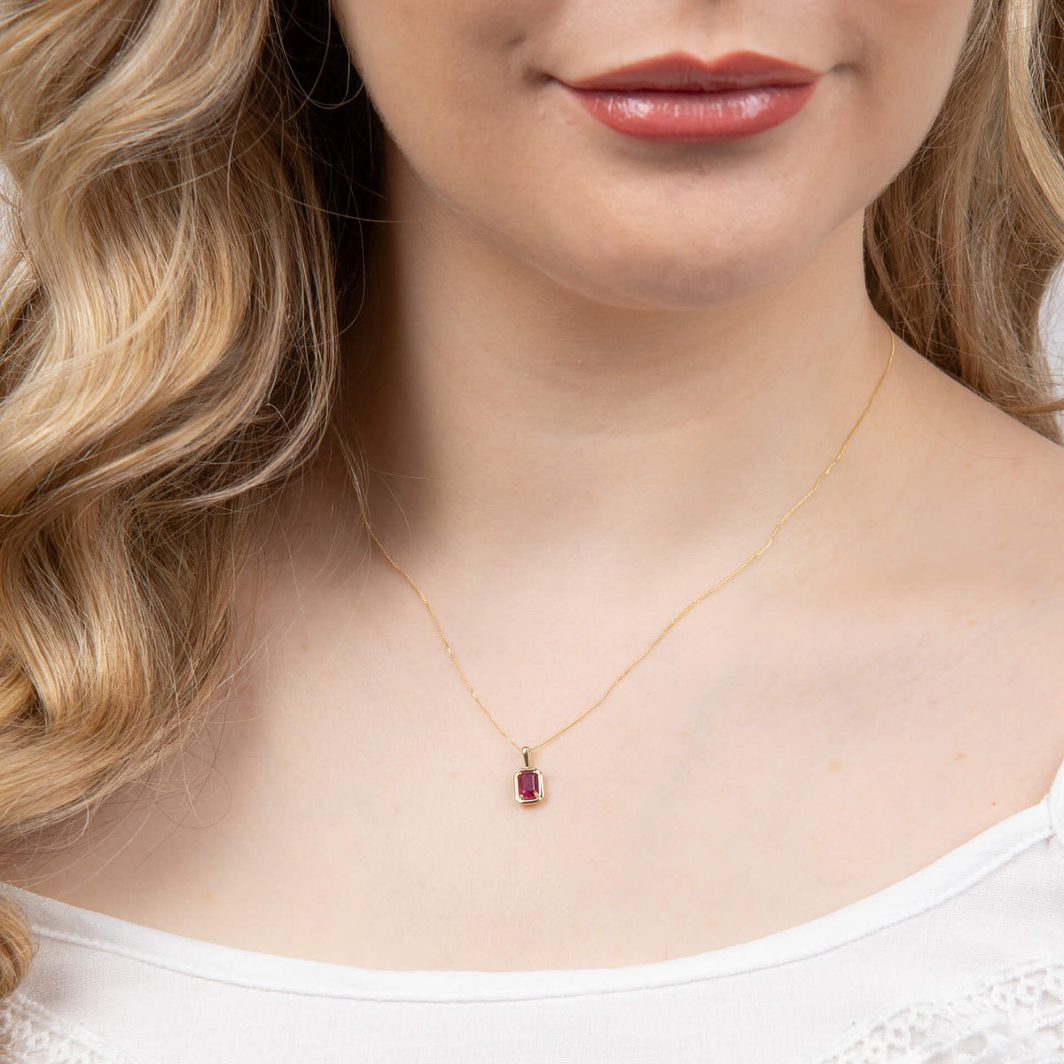 close up of woman's neck wearing Chunky Border Precious Stone ruby Gold Pendant Necklace 