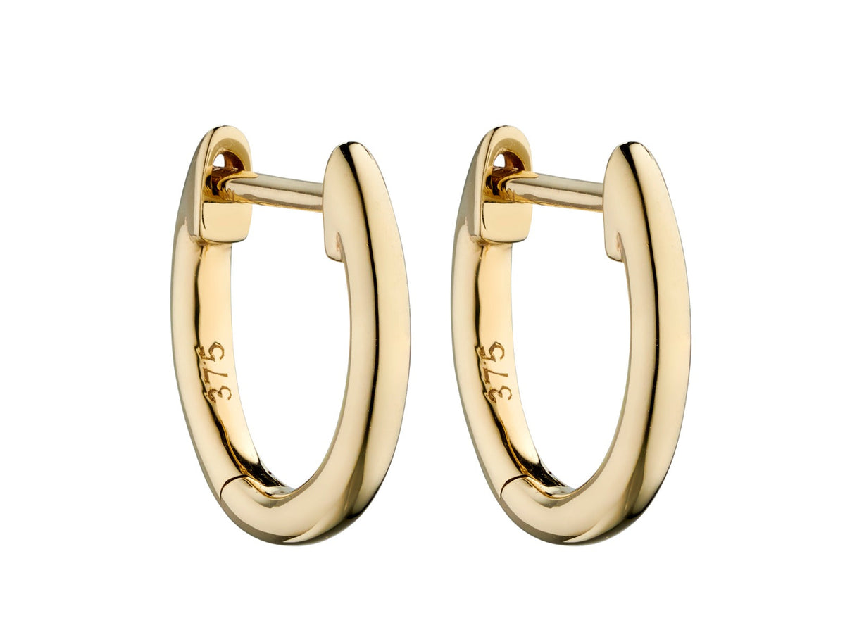 pair of gold hoop huggie earrings on white background